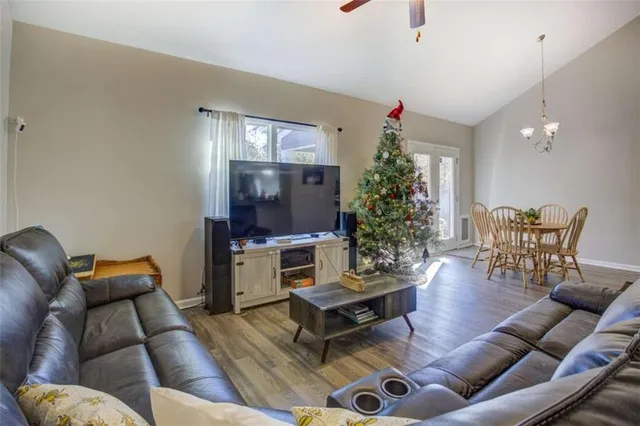 a living room with furniture a dining table and a potted plant