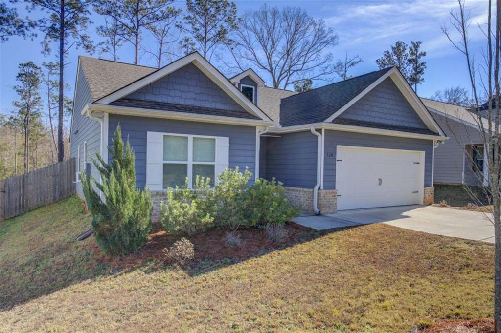 160 Savannah Way Milner, GA 30257 - Photo 36 of 41 a front view of a house with garden