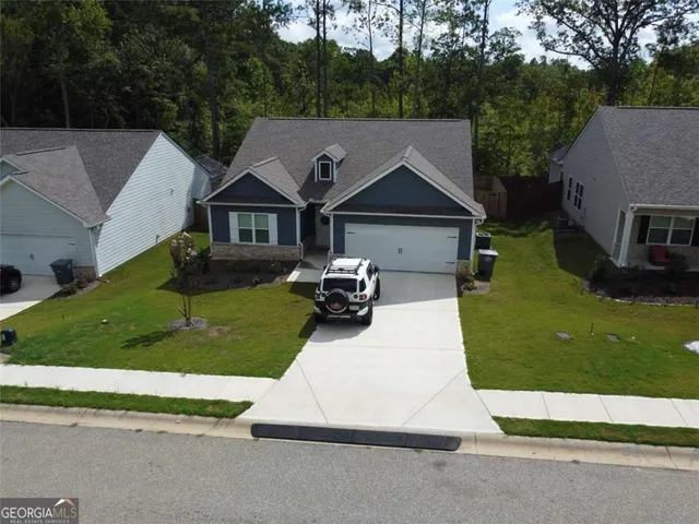 an aerial view of a house with a yard