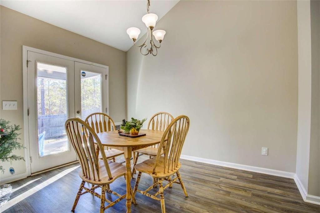 160 Savannah Way Milner, GA 30257 - Photo 5 of 41 a view of a dining room with furniture wooden floor and chandelier