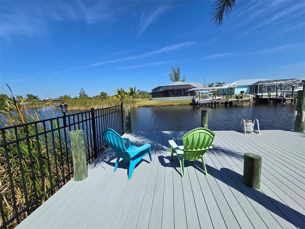a view of a balcony with chairs and wooden floor