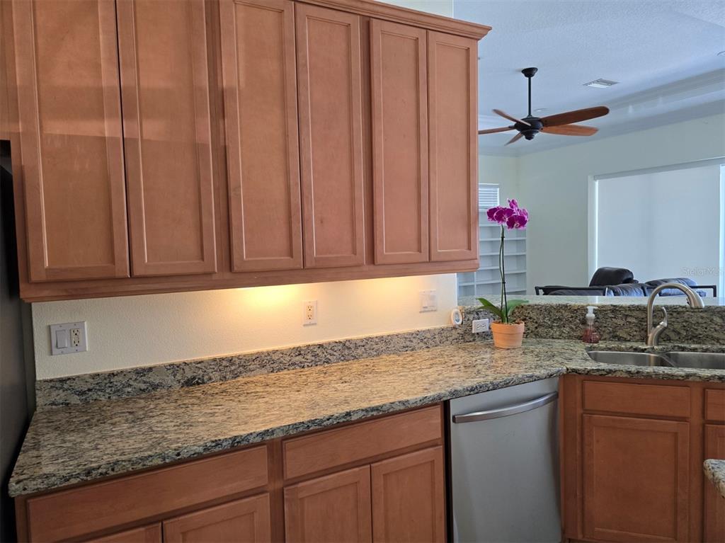 14970 Appleton Boulevard Port Charlotte, FL 33981 - Photo 34 of 48 a kitchen with granite countertop a sink stainless steel appliances white cabinets and a counter top