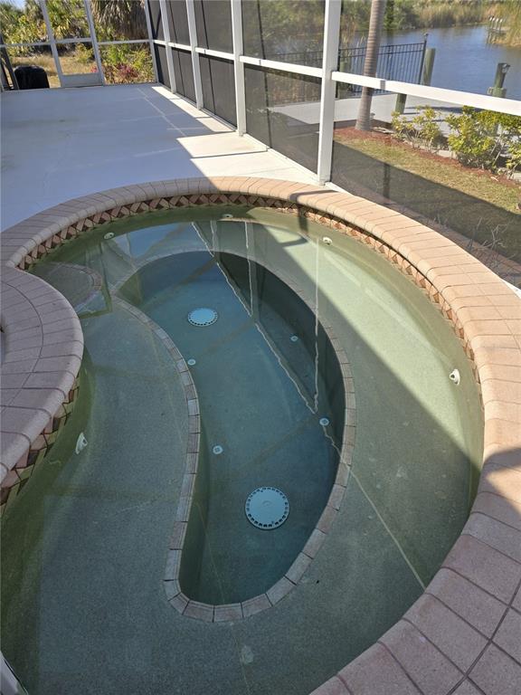 14970 Appleton Boulevard Port Charlotte, FL 33981 - Photo 6 of 48 a view of a swimming pool with a chair