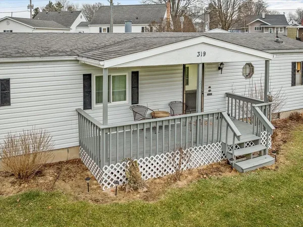 a view of a house with wooden deck