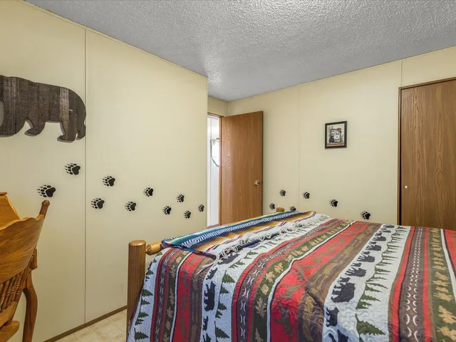 a bedroom with a bed and a painting on the wall