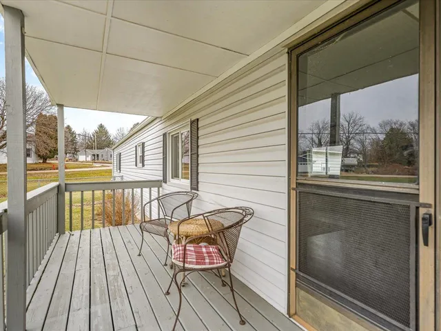 a view of a balcony with wooden floor