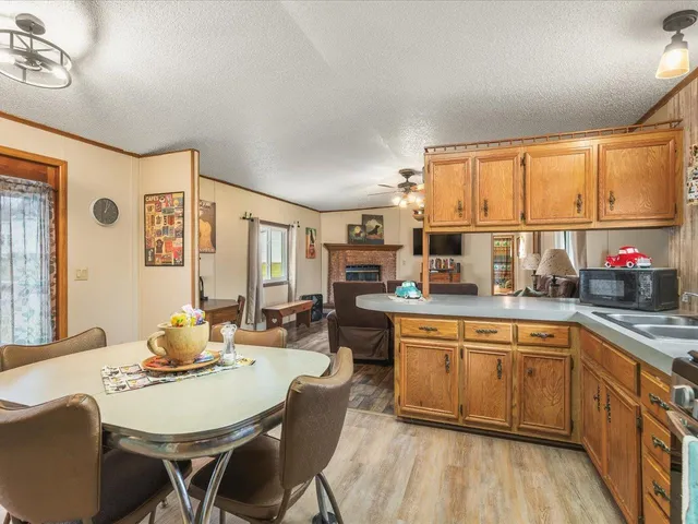 a kitchen with a dining table chairs and window