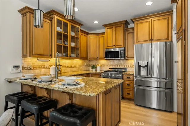 a view of a house with a yard and palm trees