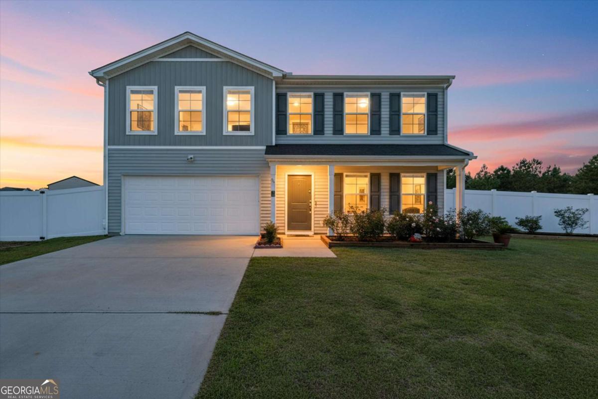 a front view of a house with garden