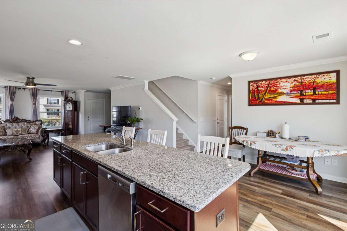 455 Tondee Way Midway, GA 31320 - Photo 15 of 52 a kitchen with sink stove and wooden floor