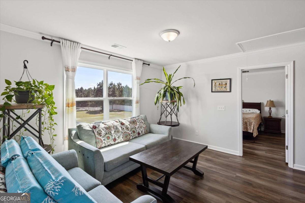 455 Tondee Way Midway, GA 31320 - Photo 18 of 52 a living room with furniture and a potted plant
