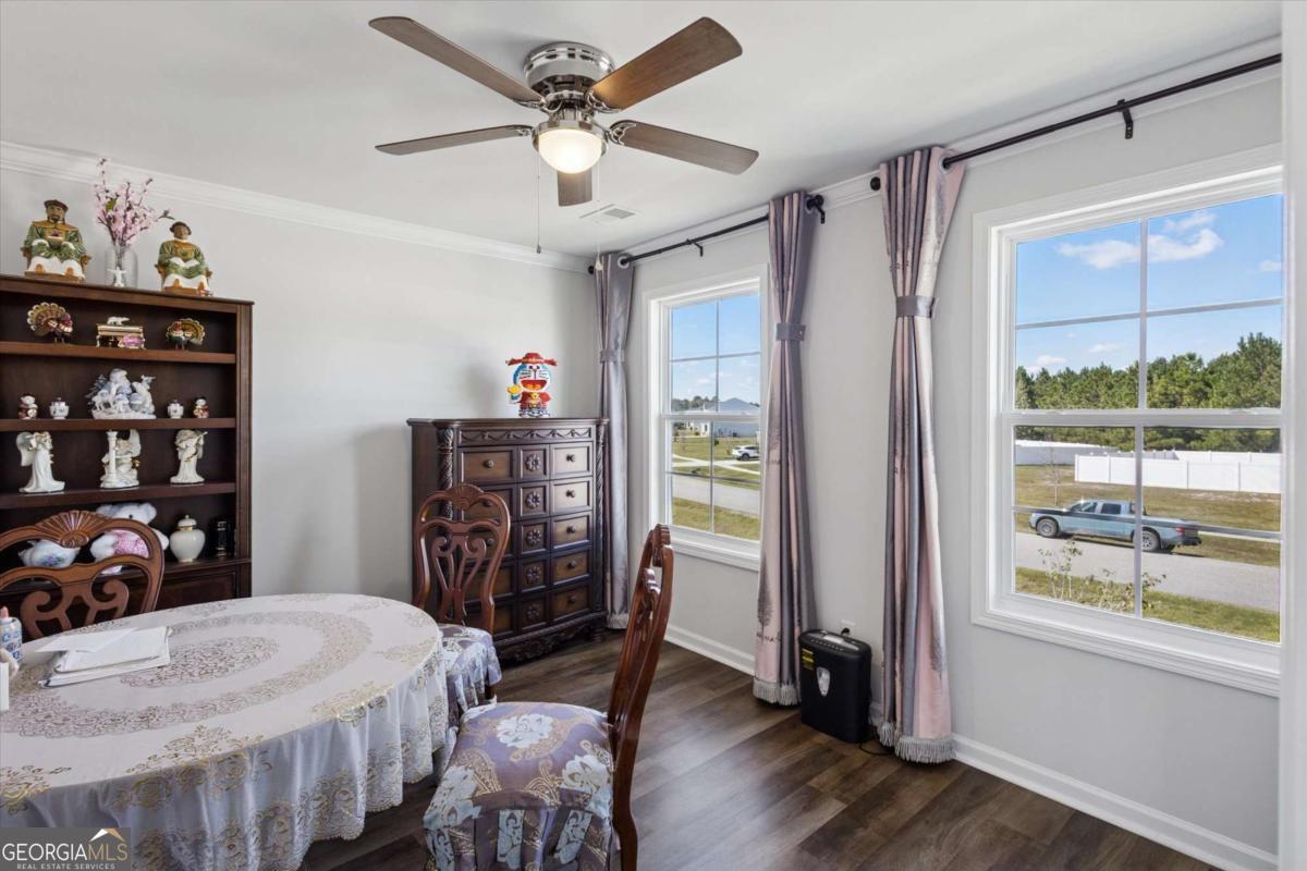 455 Tondee Way Midway, GA 31320 - Photo 20 of 52 a view of a dining room with furniture window and wooden floor