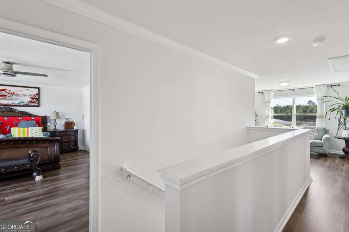 455 Tondee Way Midway, GA 31320 - Photo 23 of 52 a living room with furniture and a wooden floor