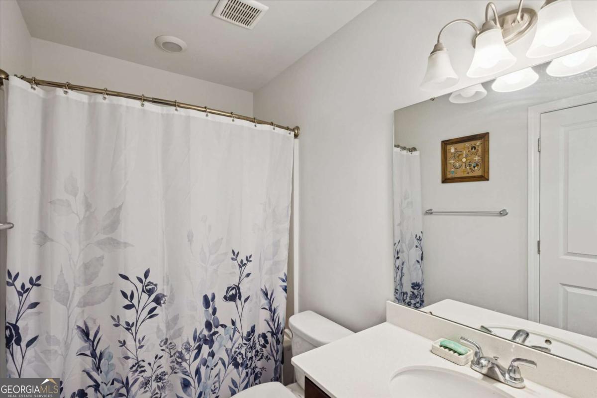 455 Tondee Way Midway, GA 31320 - Photo 24 of 52 a bathroom with a sink and a mirror
