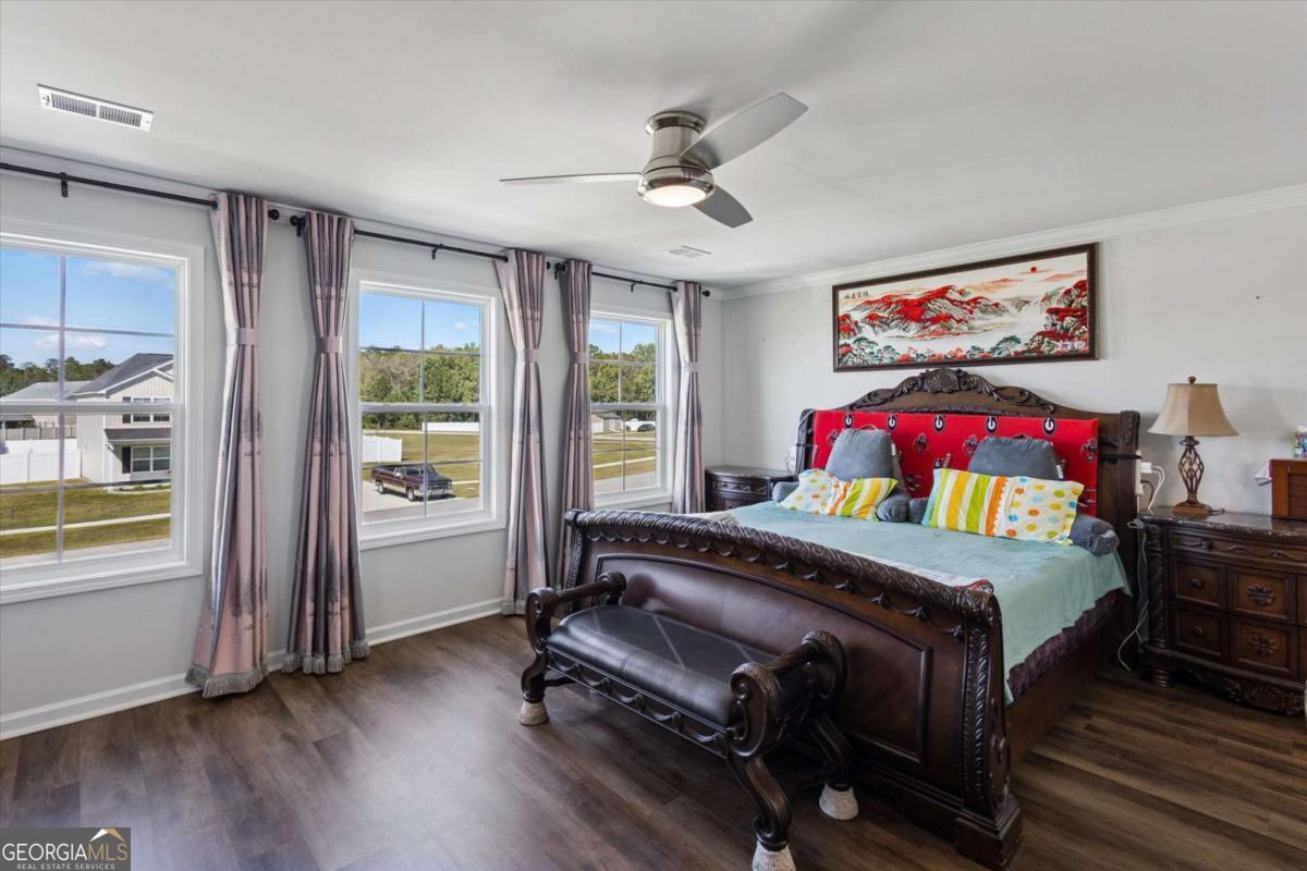 455 Tondee Way Midway, GA 31320 - Photo 27 of 52 a bedroom with a bed and a window