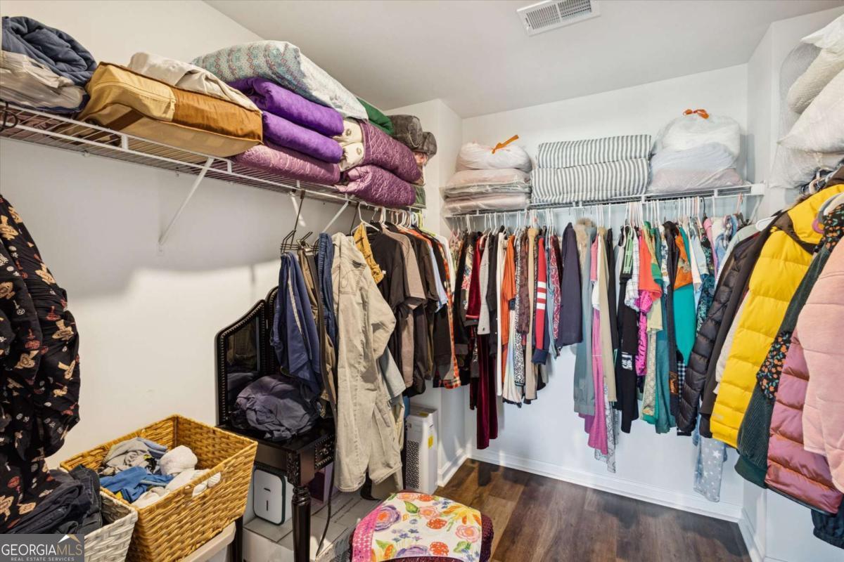 455 Tondee Way Midway, GA 31320 - Photo 29 of 52 a view of walk in closet with clothes and shoes