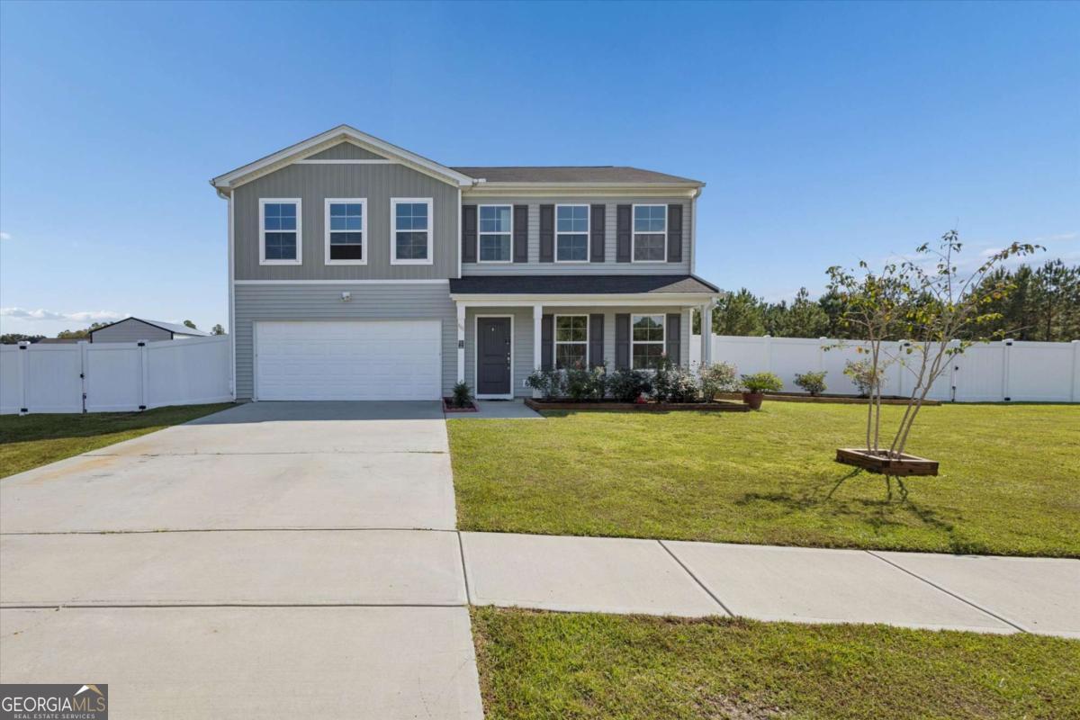 455 Tondee Way Midway, GA 31320 - Photo 3 of 52 a front view of a house with a yard