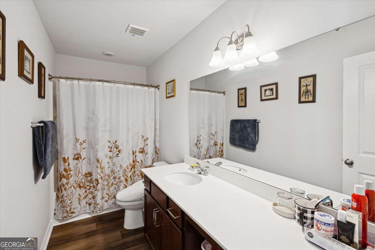 455 Tondee Way Midway, GA 31320 - Photo 32 of 52 a bathroom with a sink vanity and a mirror