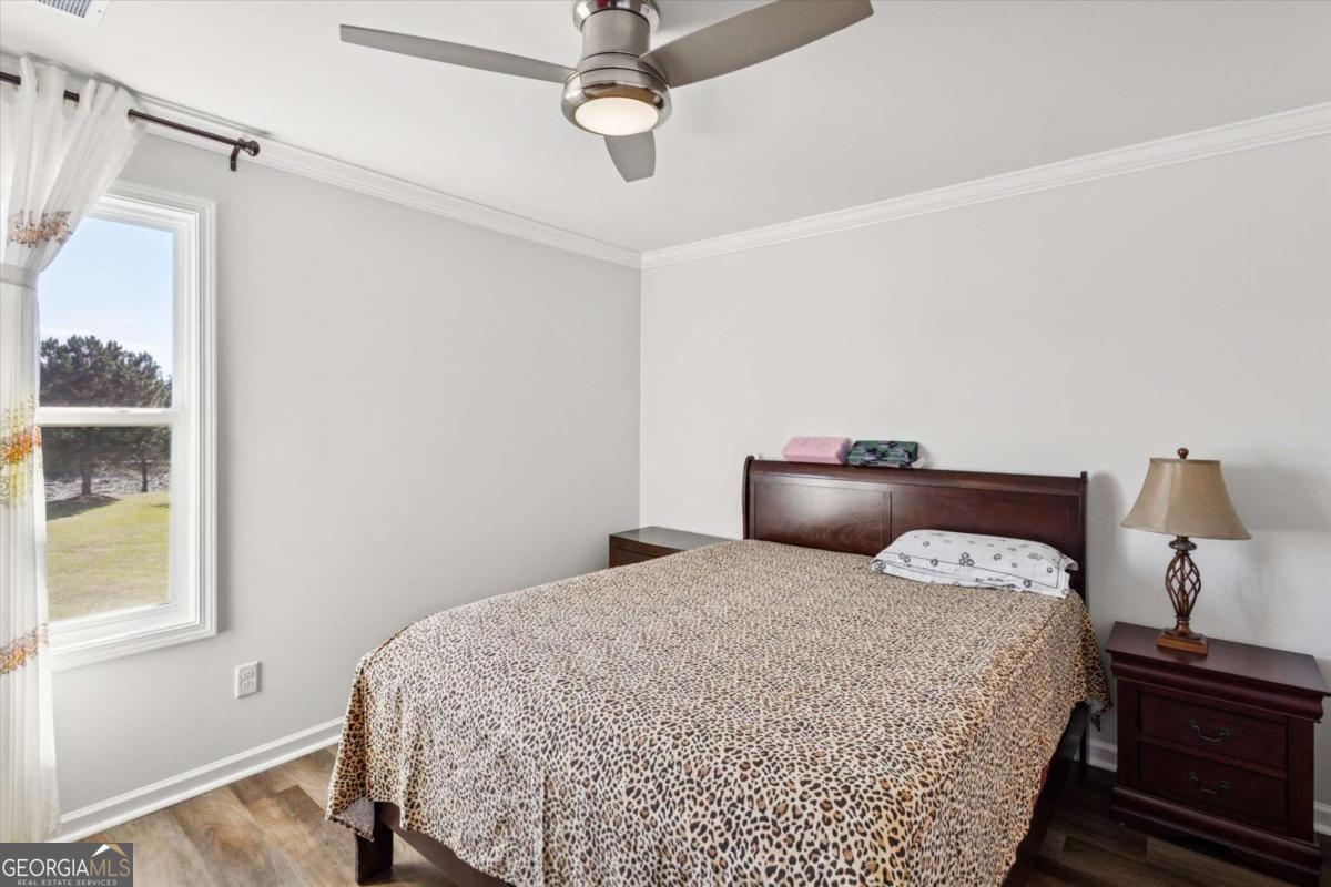 455 Tondee Way Midway, GA 31320 - Photo 33 of 52 a bedroom with a bed and window