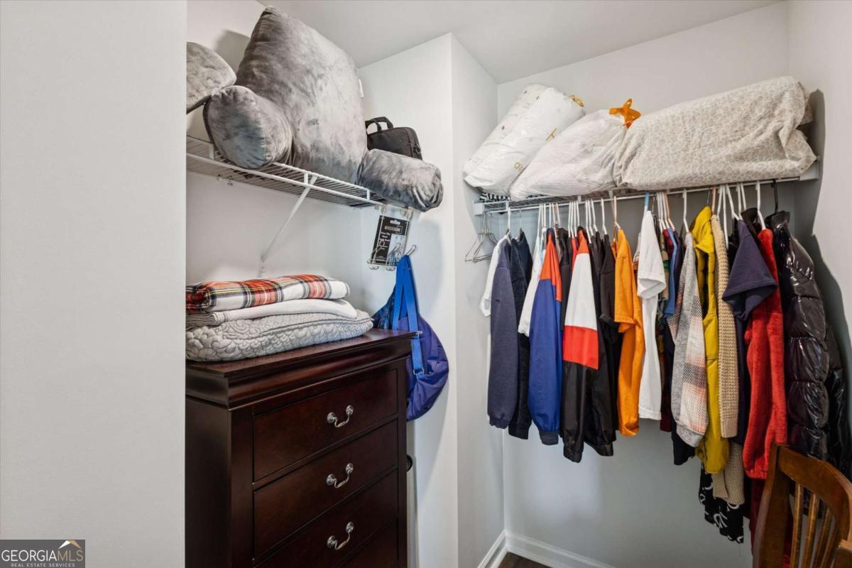 455 Tondee Way Midway, GA 31320 - Photo 35 of 52 a view of walk in closet with clothes and shoes