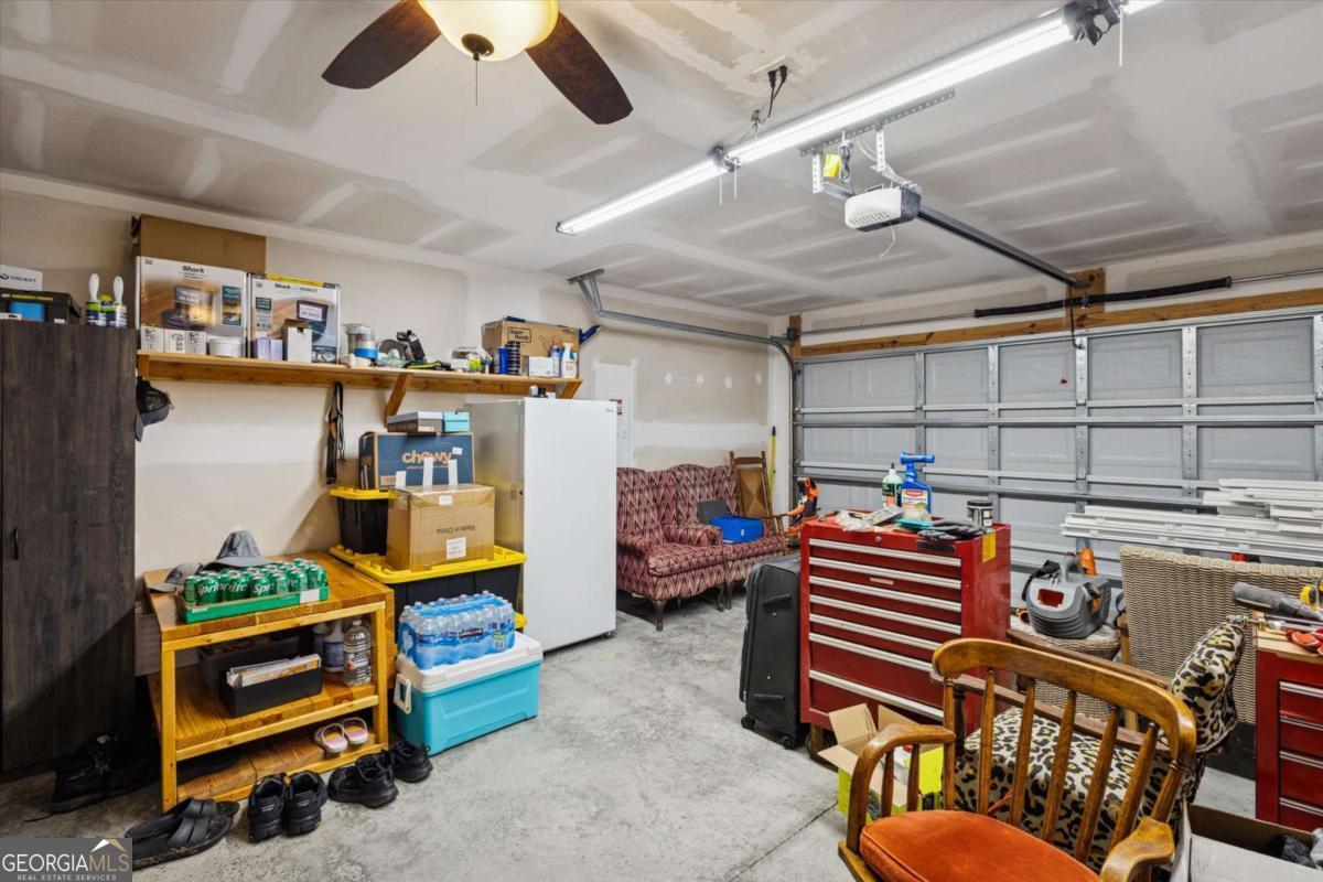 455 Tondee Way Midway, GA 31320 - Photo 40 of 52 a dining room with furniture and a flat screen tv