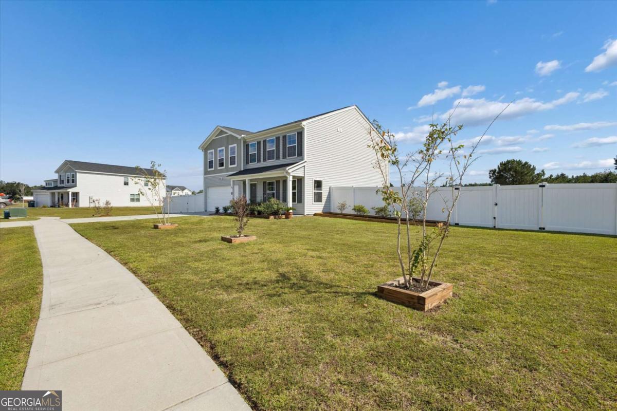 455 Tondee Way Midway, GA 31320 - Photo 4 of 52 a swimming pool with outdoor seating and yard