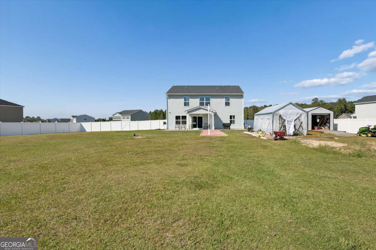 455 Tondee Way Midway, GA 31320 - Photo 46 of 52 a house view with swimming pool in front of it