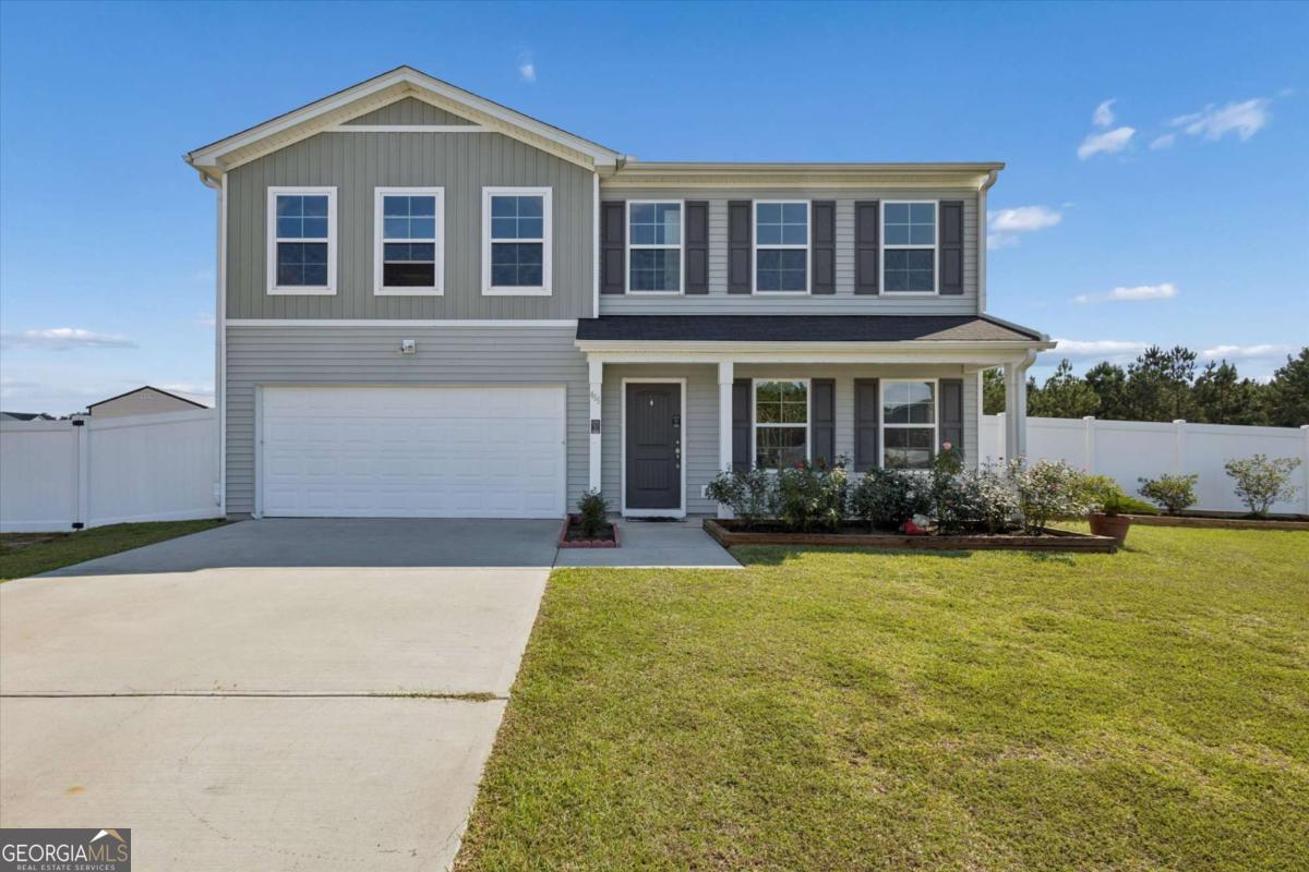 455 Tondee Way Midway, GA 31320 - Photo 5 of 52 a front view of a house with a yard