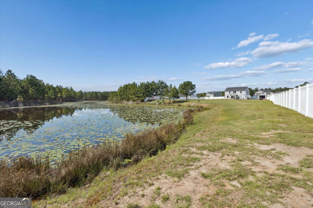 455 Tondee Way Midway, GA 31320 - Photo 51 of 52 a view of a lake with houses in the background