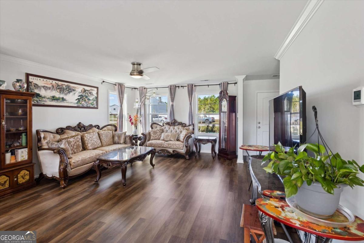 455 Tondee Way Midway, GA 31320 - Photo 7 of 52 a living room with furniture potted plant and a window