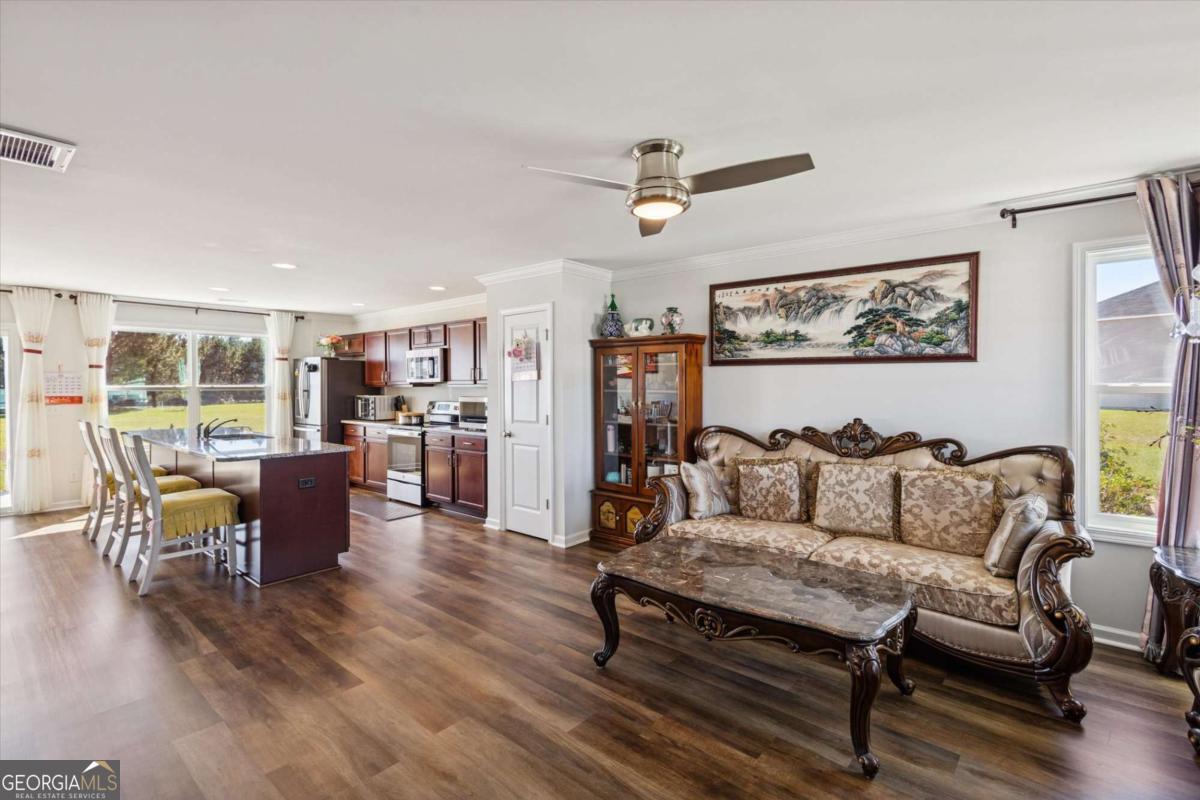 455 Tondee Way Midway, GA 31320 - Photo 8 of 52 a living room with furniture and a view of kitchen