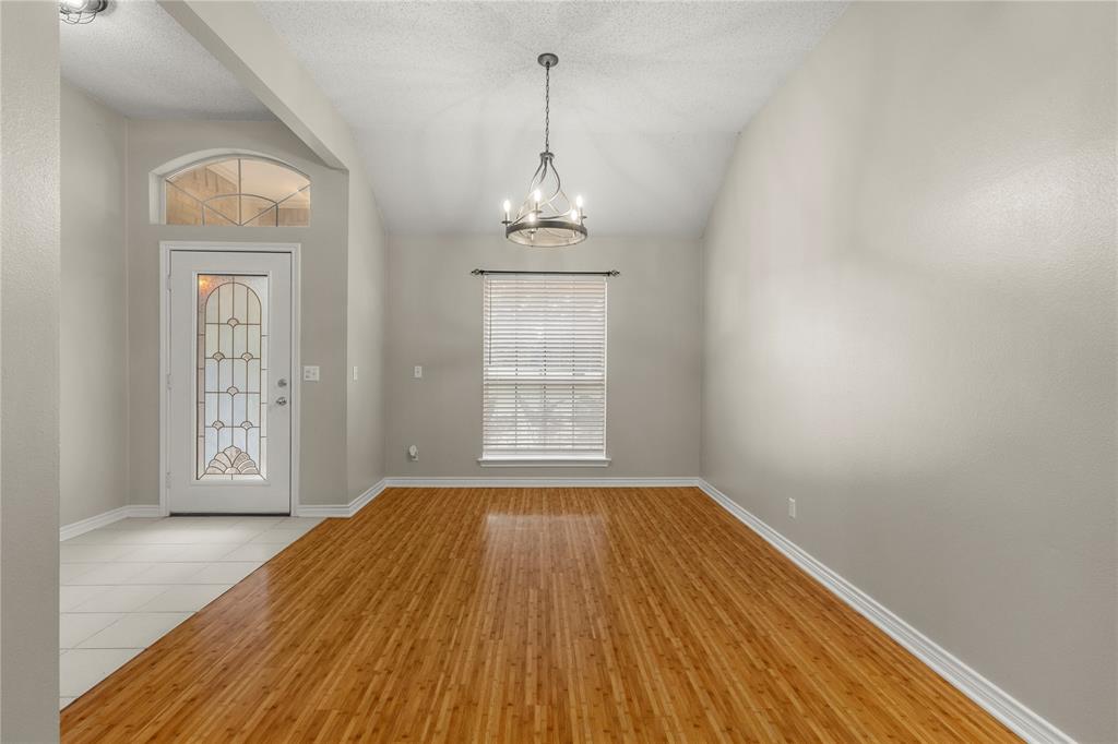 2917 Harlow Road Commerce, TX 75428 - Photo 7 of 40 wooden floor in an empty room with a window