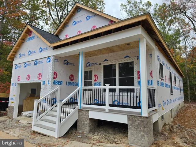 a view of a house with wooden deck front door