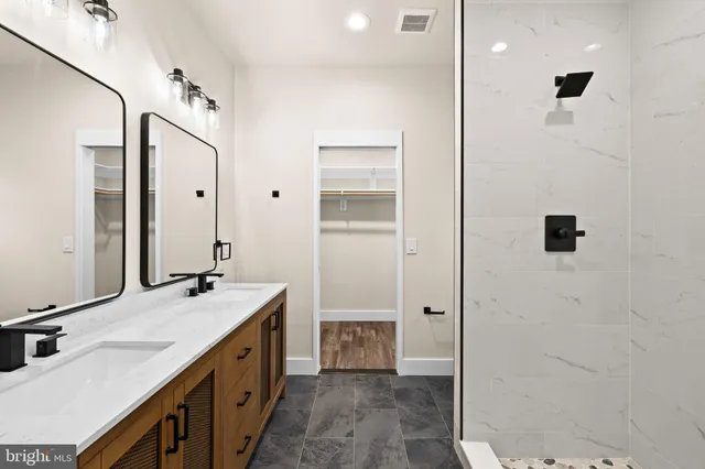 a bathroom with a double vanity sink and a mirror