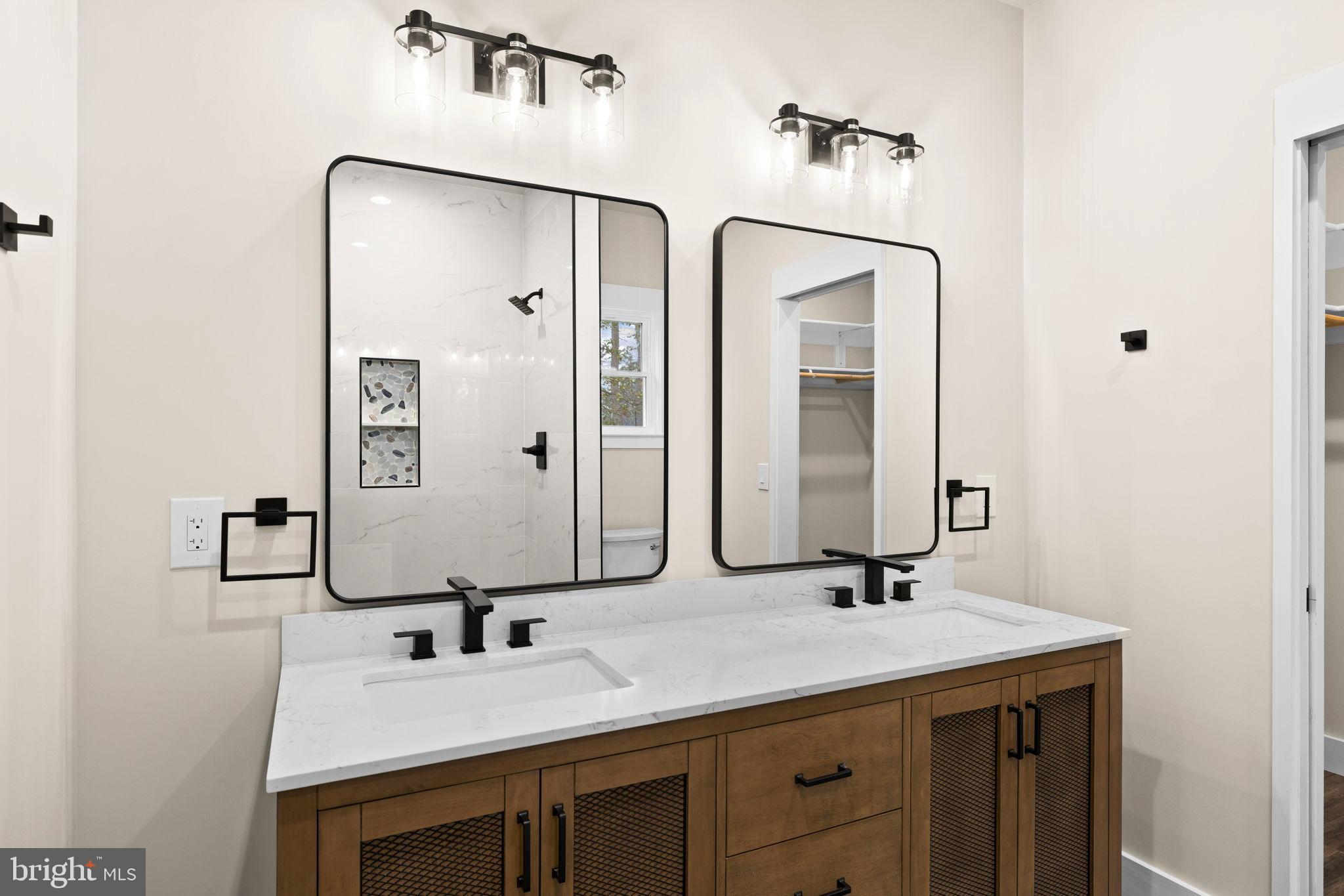 312 9th Street Colonial Beach, VA 22443 - Photo 14 of 59 a bathroom with a double vanity sink and a mirror