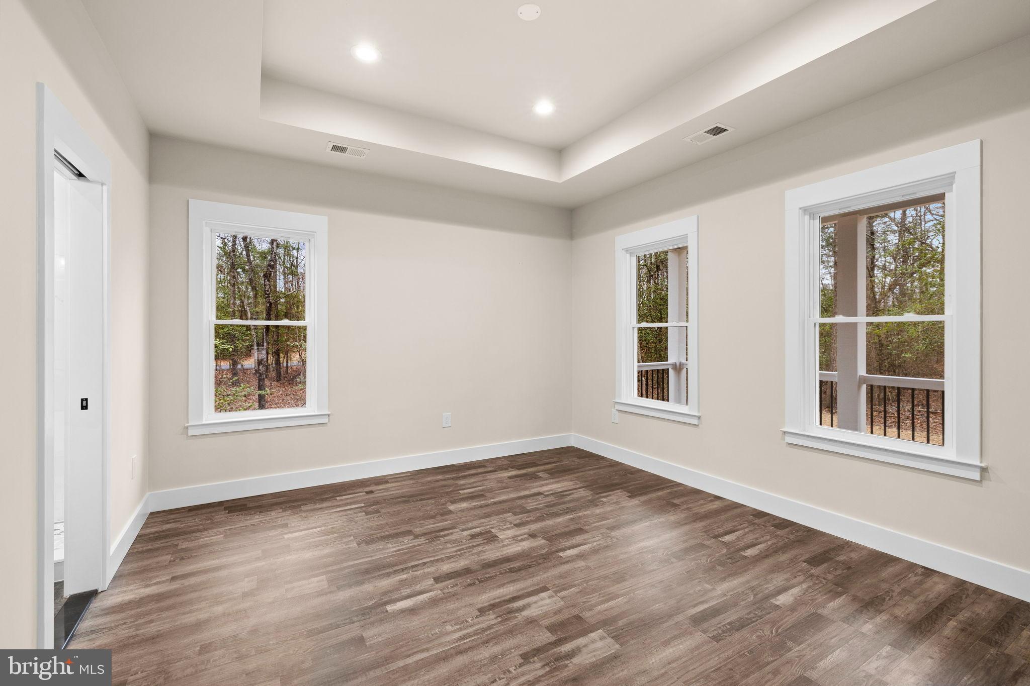 312 9th Street Colonial Beach, VA 22443 - Photo 17 of 59 a view of an empty room with wooden floor and a window