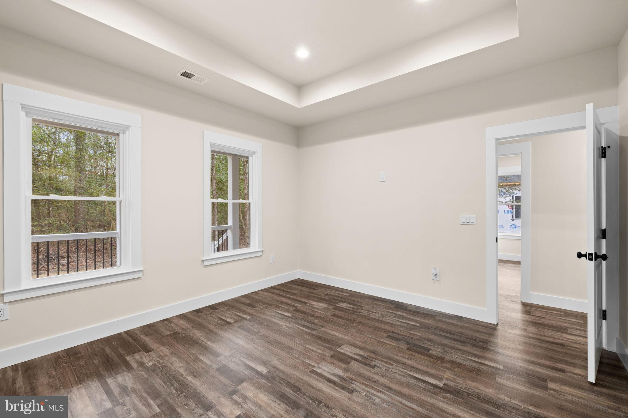 312 9th Street Colonial Beach, VA 22443 - Photo 19 of 59 a view of an empty room with wooden floor and a window
