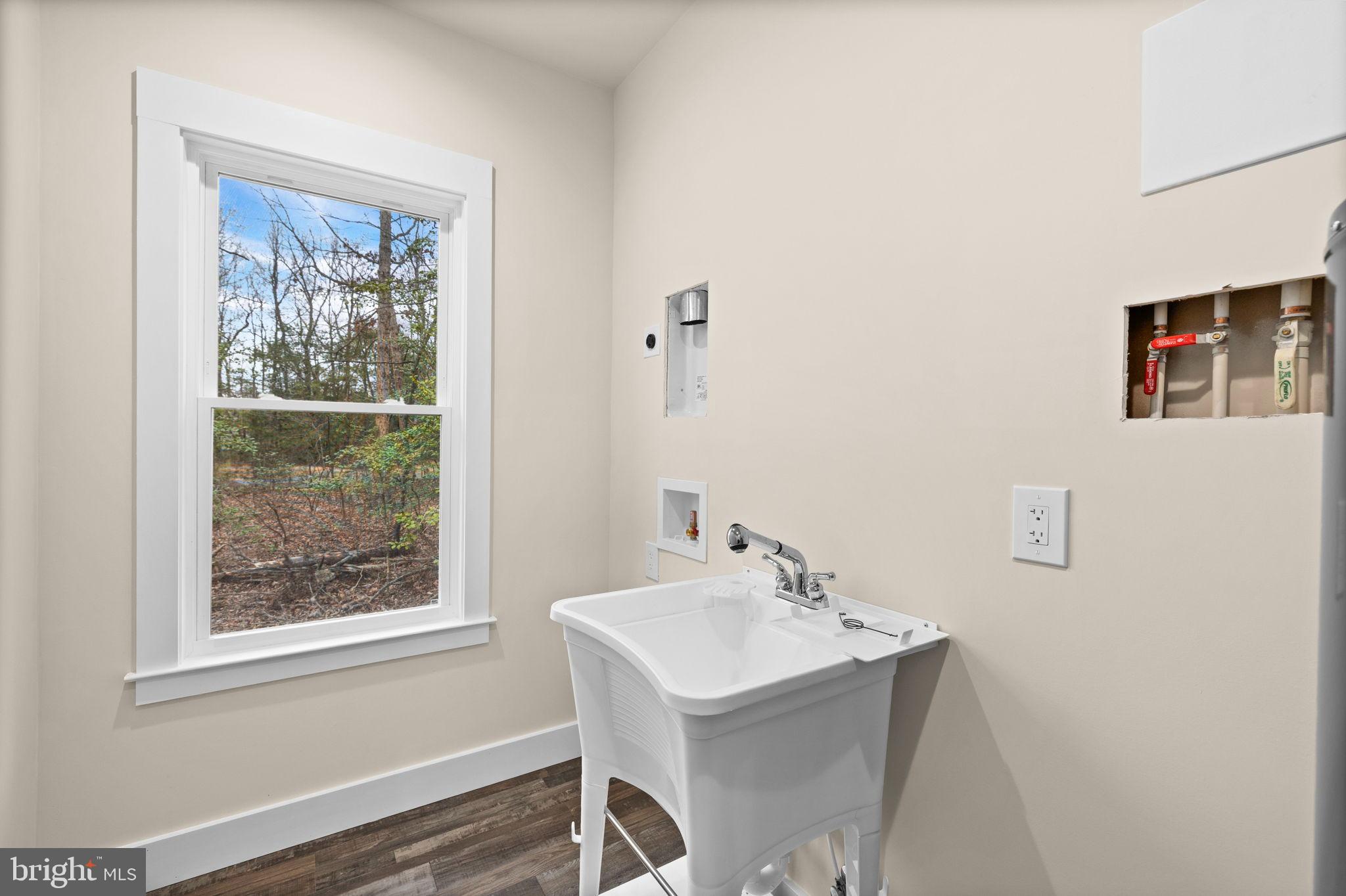 312 9th Street Colonial Beach, VA 22443 - Photo 27 of 59 a bathroom with a sink mirror and a window