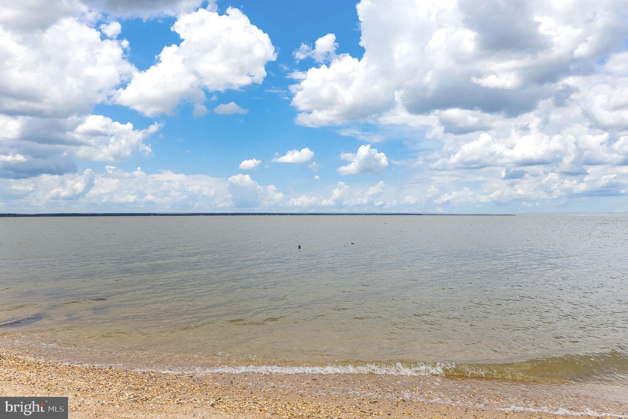 312 9th Street Colonial Beach, VA 22443 - Photo 34 of 59 Serene shoreline under a vast blue sky.