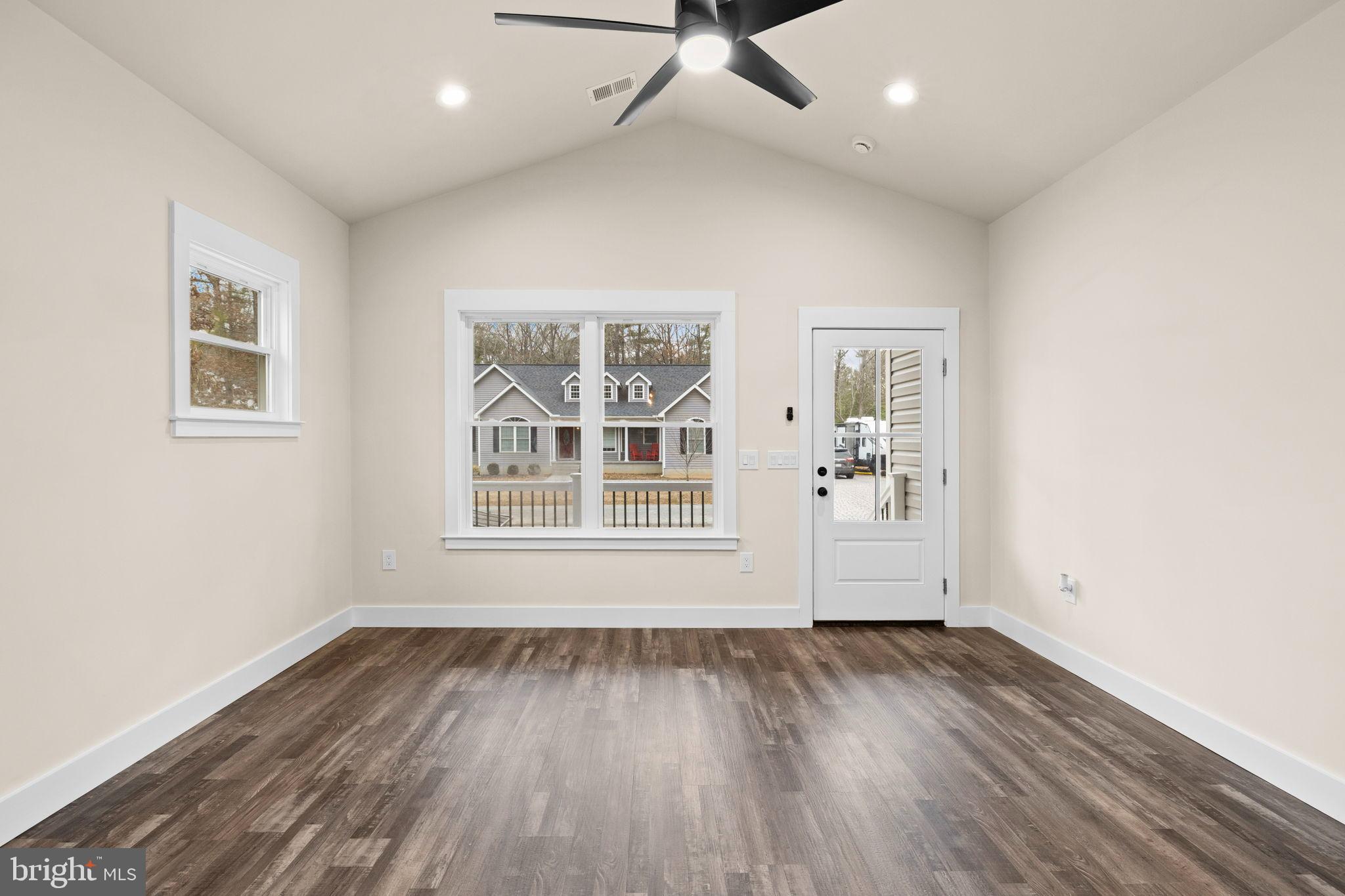 312 9th Street Colonial Beach, VA 22443 - Photo 52 of 59 an empty room with wooden floor and windows