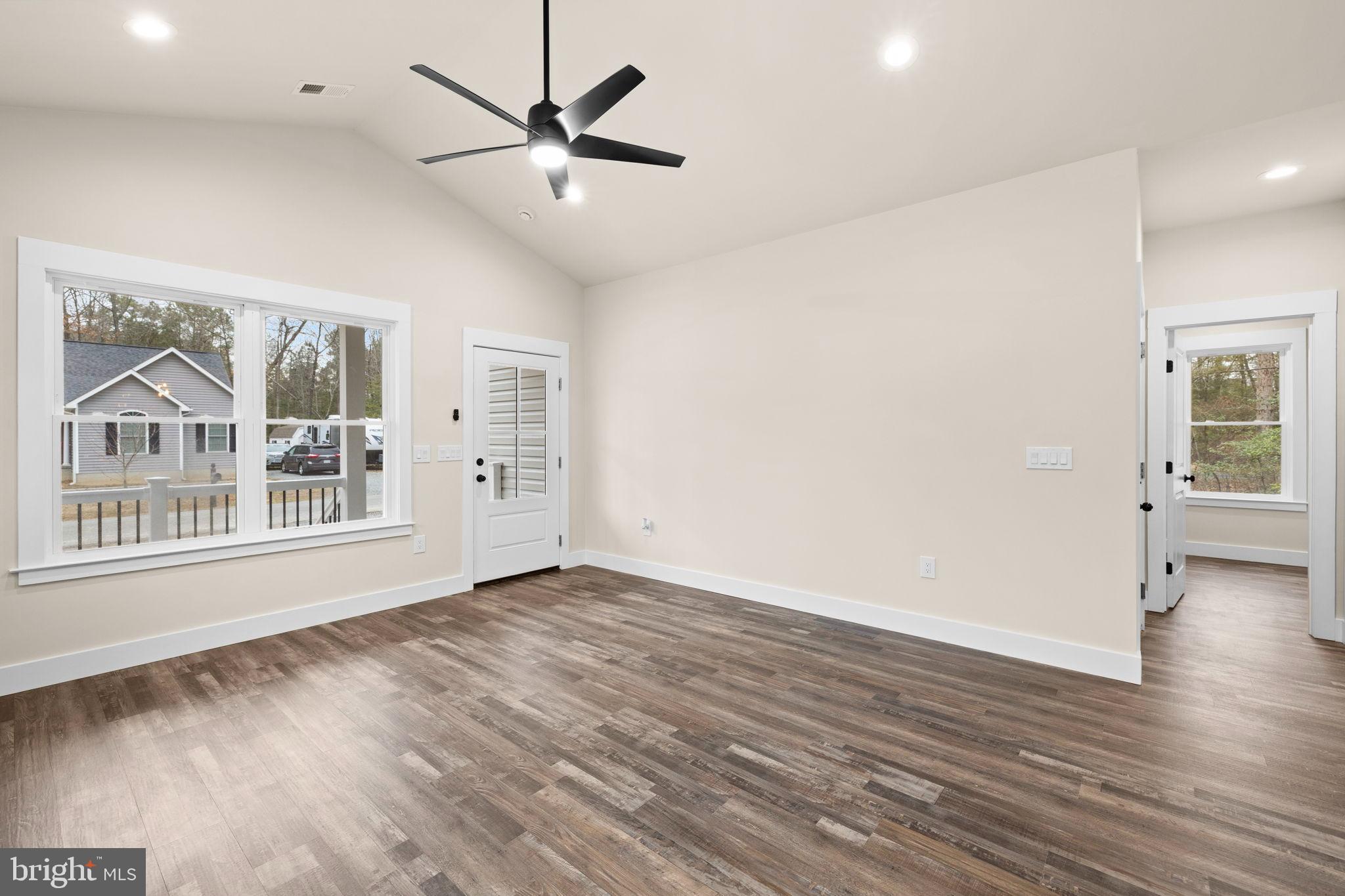 312 9th Street Colonial Beach, VA 22443 - Photo 53 of 59 an empty room with wooden floor and windows