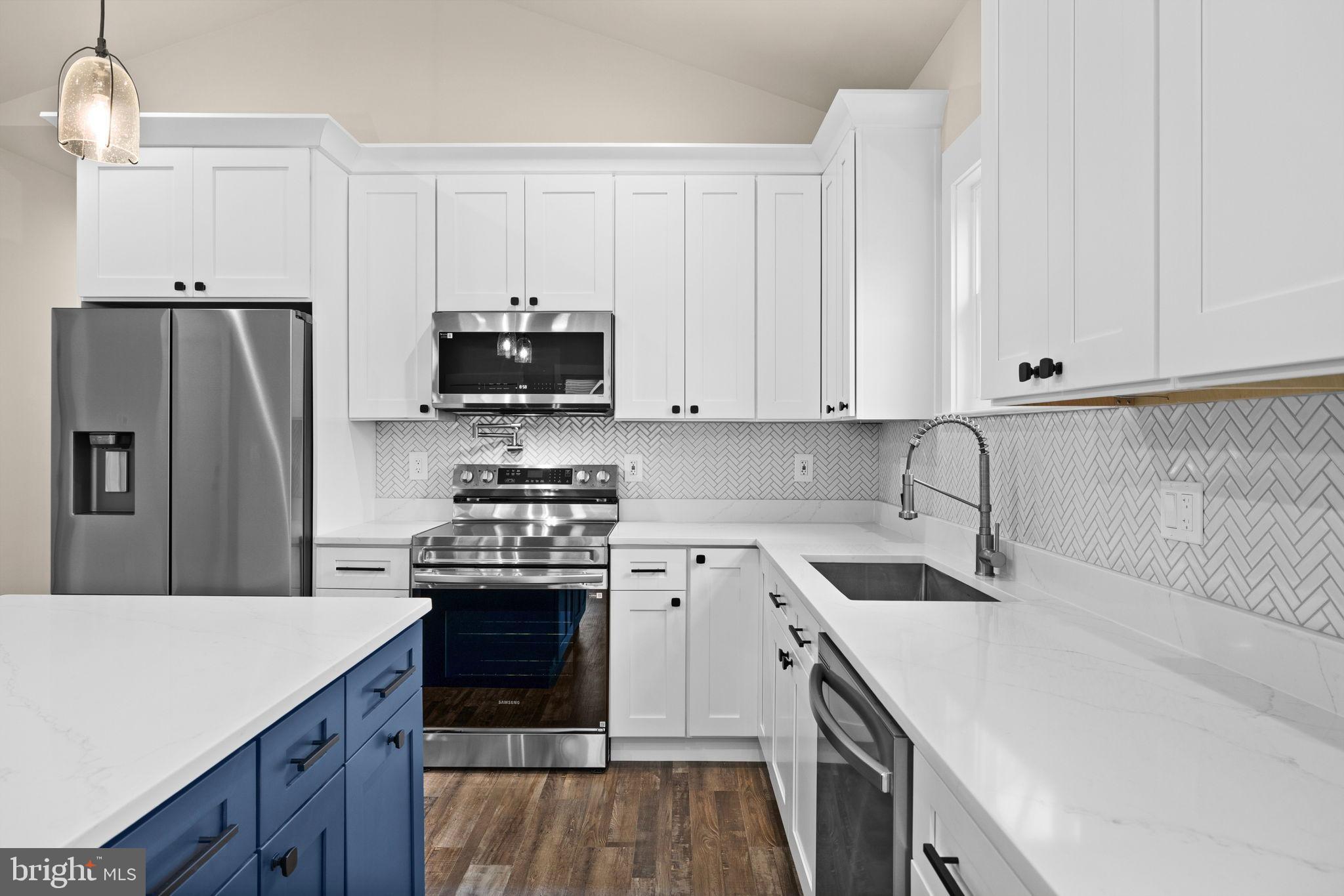 312 9th Street Colonial Beach, VA 22443 - Photo 10 of 59 Modern kitchen with sleek finishes.