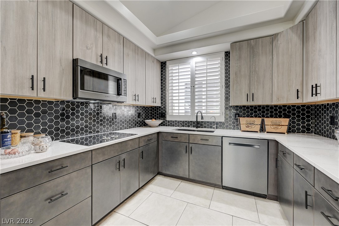 457 Indigo Springs Street Henderson, NV 89014 - Photo 10 of 58 Remodeled kitchen with electric cooktop and Bosch appliances.