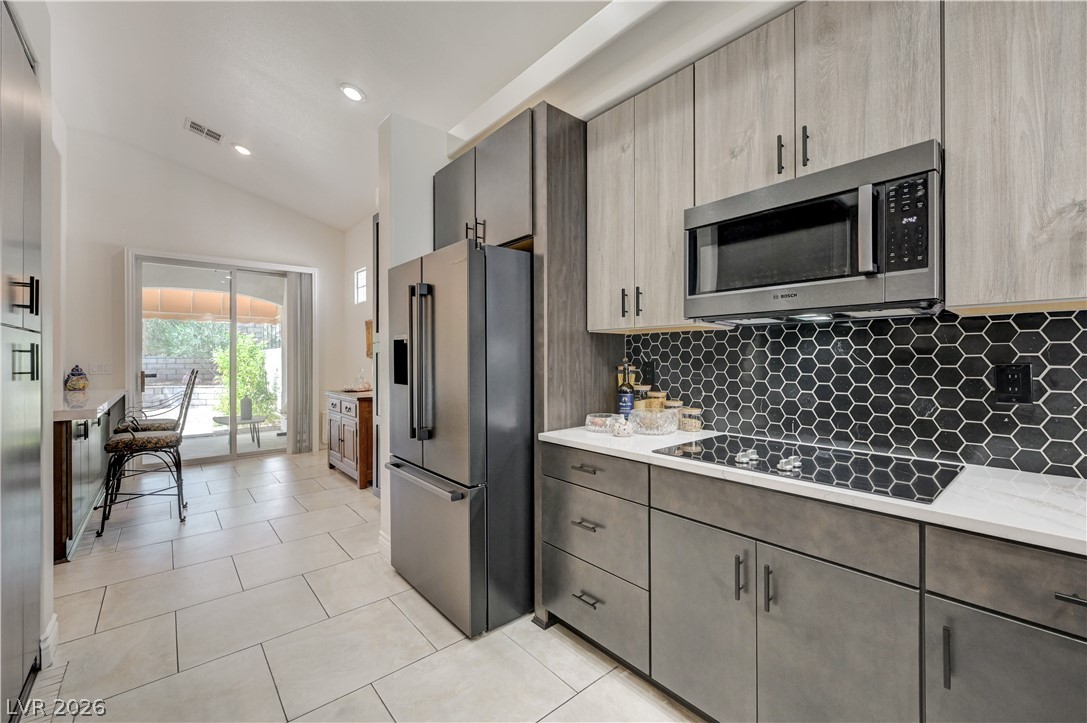 457 Indigo Springs Street Henderson, NV 89014 - Photo 13 of 58 Kitchen opens to a kitchen eating area with breakfast bar and outdoor patio.