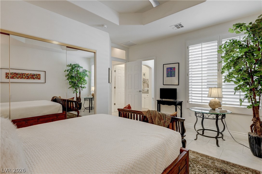 457 Indigo Springs Street Henderson, NV 89014 - Photo 26 of 58 2nd Bedroom with ceiling fan, mirrored closet doors and shared bathroom.