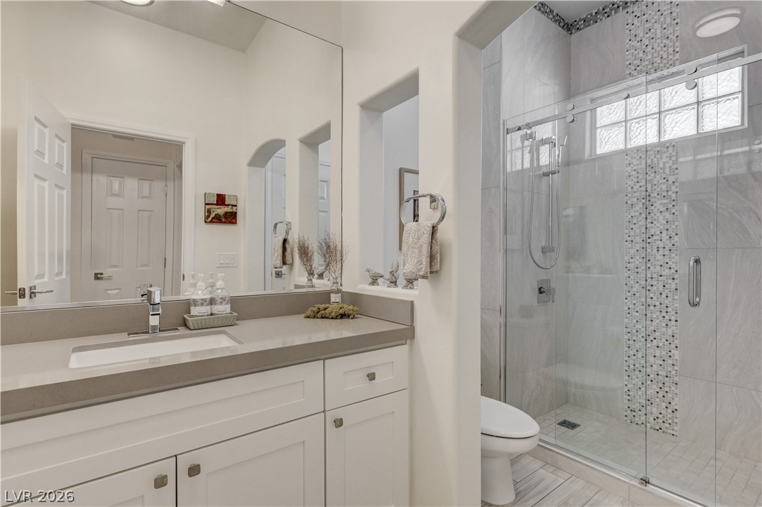 457 Indigo Springs Street Henderson, NV 89014 - Photo 30 of 58 Shared bath with glass enclosed shower, undermount sink and grab bar