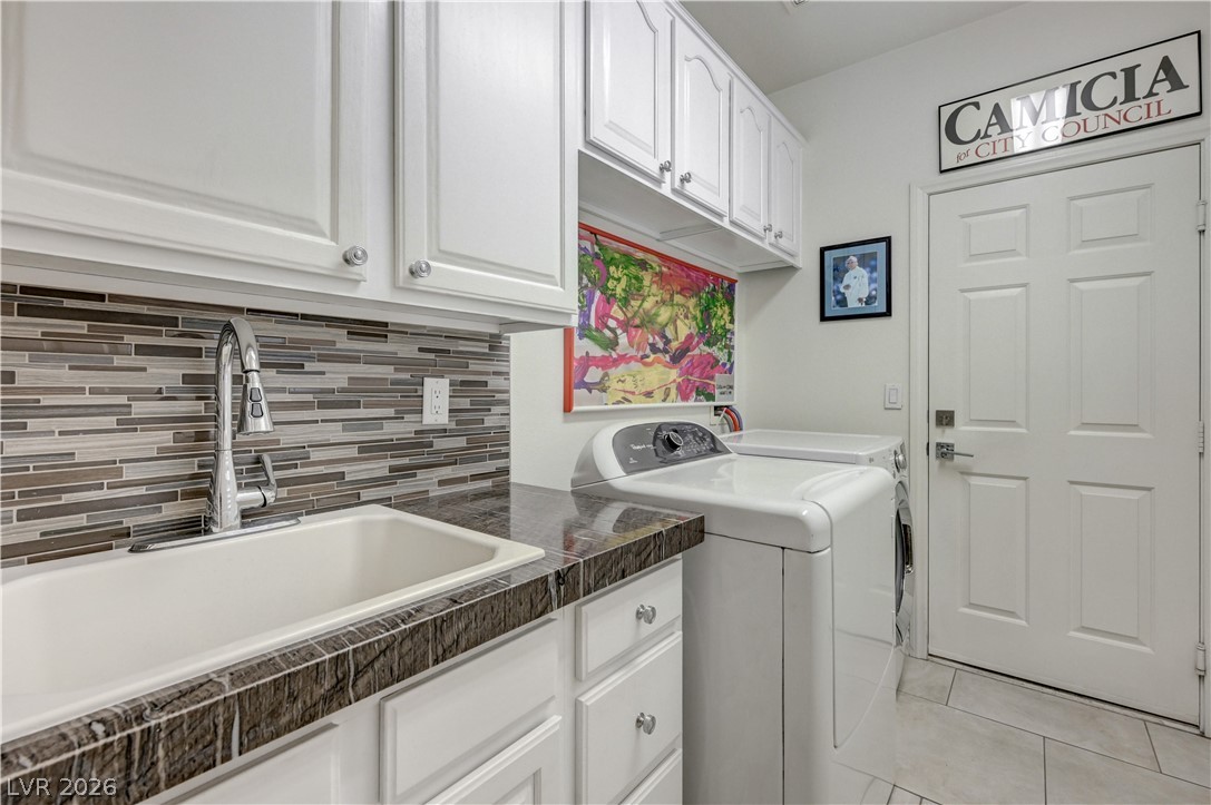457 Indigo Springs Street Henderson, NV 89014 - Photo 35 of 58 Laundry room with built in cabinets and sink is located at the garage entry.