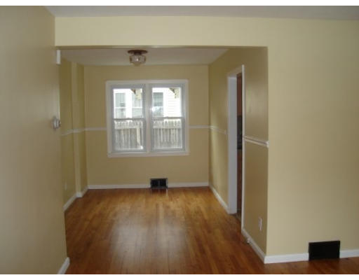 6 Alsace Street Springfield, MA 01108 - Photo 4 of 11 a view of an empty room with wooden floor and a window