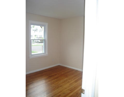 6 Alsace Street Springfield, MA 01108 - Photo 5 of 11 a view of an empty room with wooden floor and a window