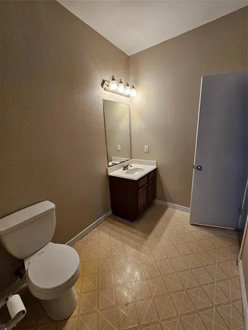 a bathroom with a sink toilet and mirror